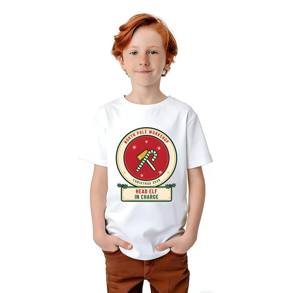 Boy wearing the Build Your Own Badge personalized kids Christmas shirt in White, with HEAD ELF IN CHARGE on the name plate